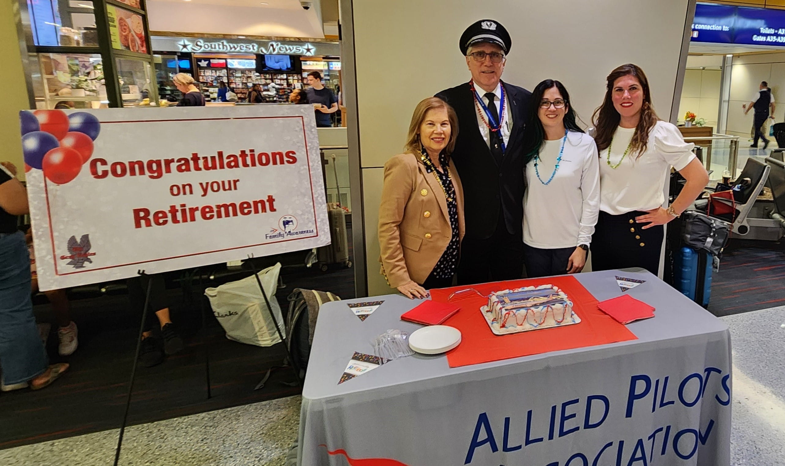 a pilot with his family and a cake